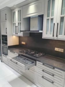 Modern kitchen with stainless steel appliances and sleek cabinetry.