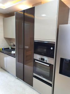 Modern kitchen with stainless steel appliances and sleek cabinetry.